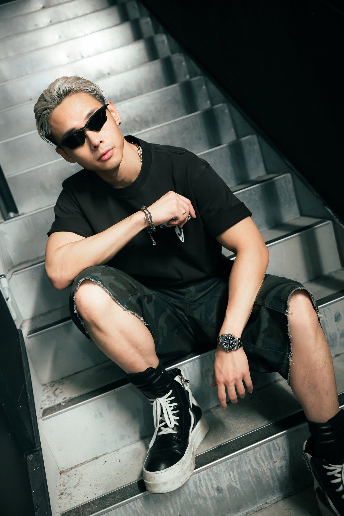 Metallic Cross Tee worn seated, stairwell