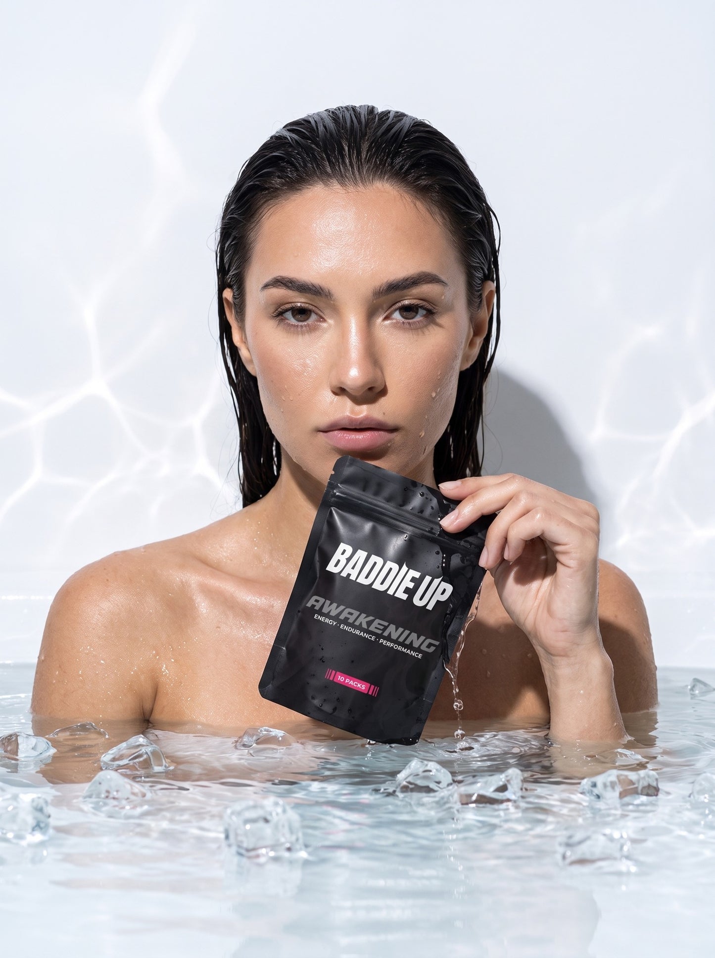 Model with BADDIE UP AWAKENING pouch in ice bath — recovery by morning