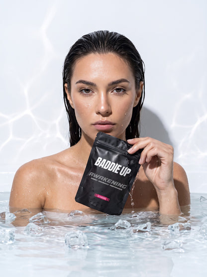 Model with BADDIE UP AWAKENING pouch in ice bath — recovery by morning