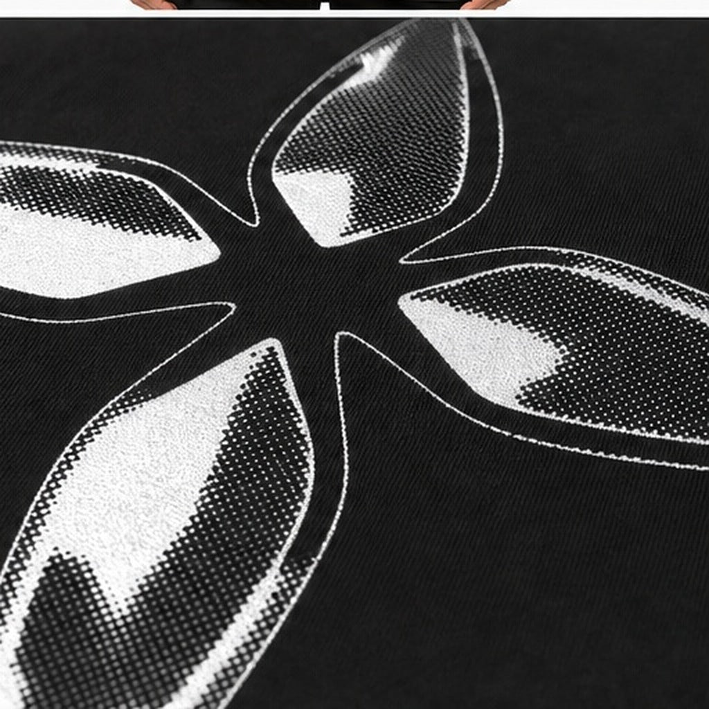 Halftone detail — the chrome cross printed on black cotton